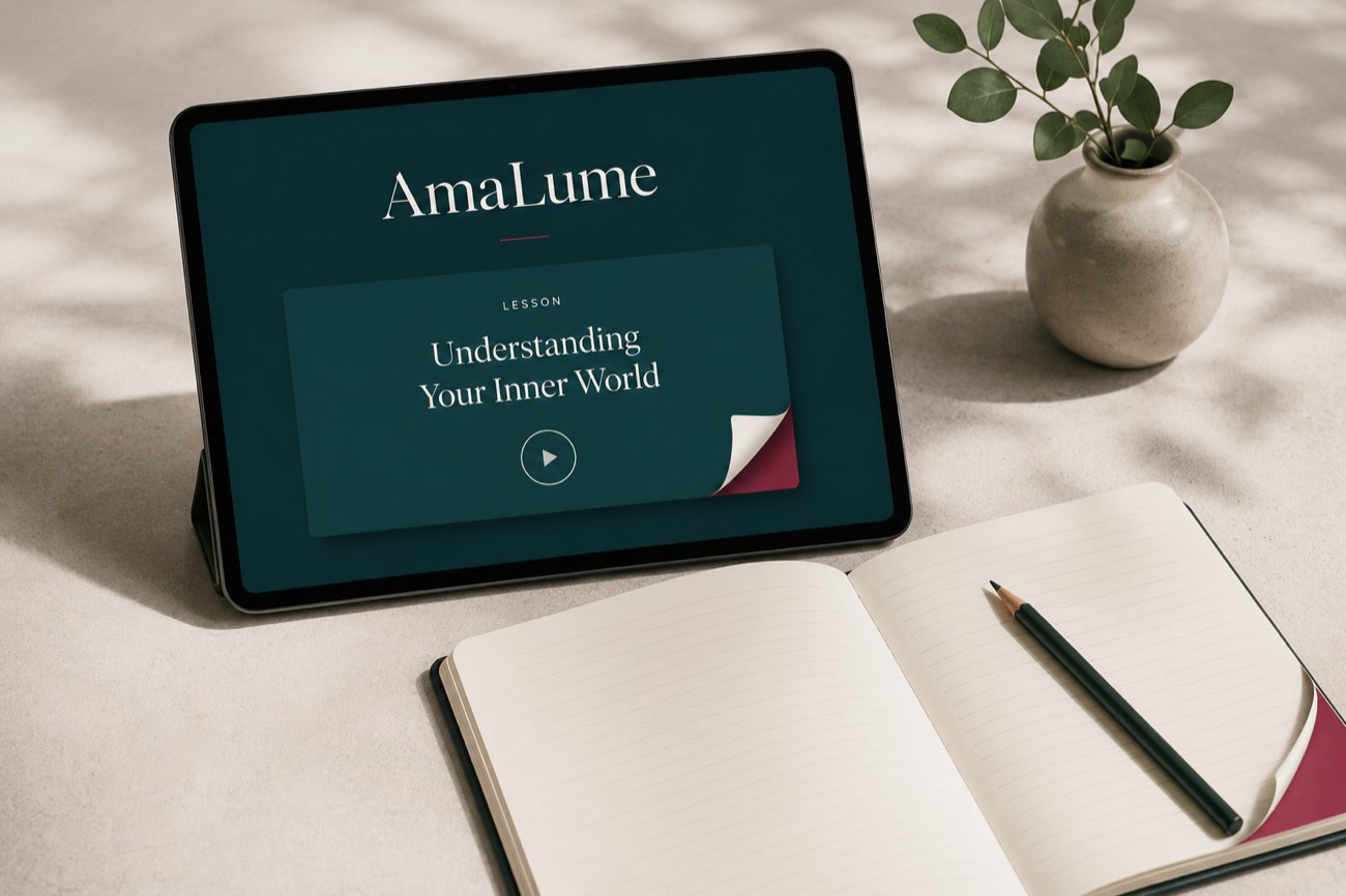 A tablet showing an AmaLume lesson beside an open notebook