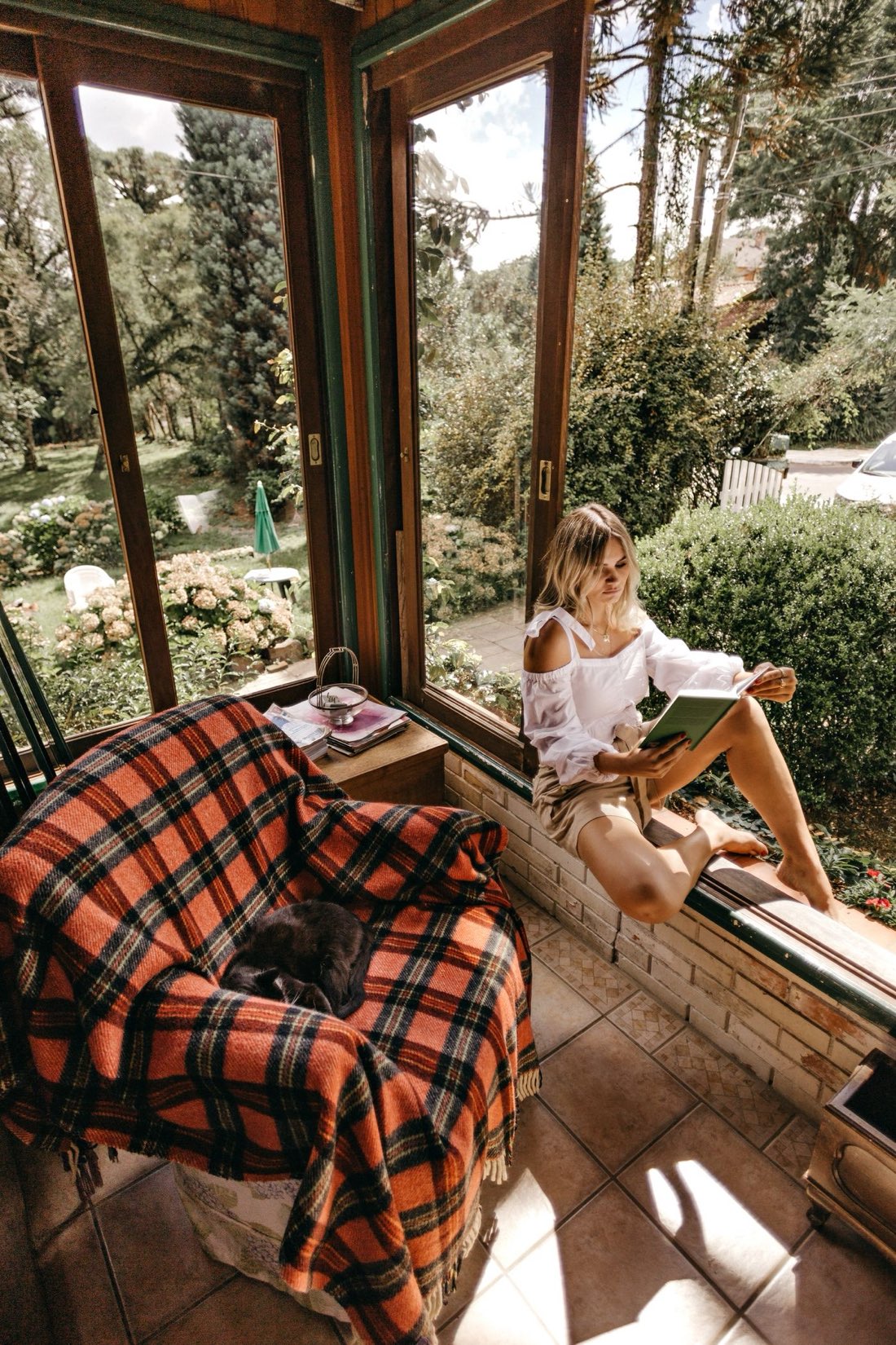 A woman sitting quietly by a window